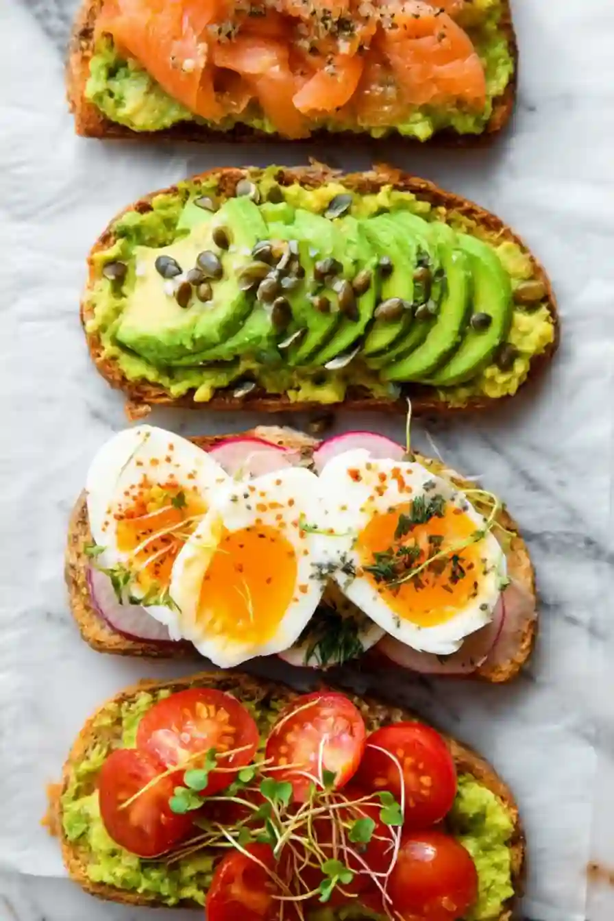Close-up of assorted avocado toast with fresh toppings on parchment