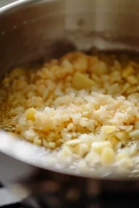 Sweet Potato and Chickpea Curry: Creamy Comfort with a Protein Boost 11 Fresh garlic and grated ginger cooking with onions in a curry pot