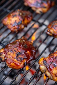 Hawaiian BBQ Chicken (High-Protein) 12 Hawaiian BBQ chicken grilling with caramelized glaze and charred edges on a clean grill
