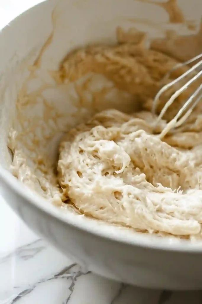 Air Fryer Churro Bites Crispy, Golden & Irresistibly Easy 3 Silky churro dough being mixed with egg and vanilla extract in a bowl
