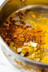 Sweet Potato and Chickpea Curry: Creamy Comfort with a Protein Boost 12 Curry powder turmeric and cumin toasting with onions garlic and ginger