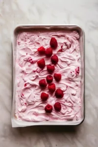 Raspberry Frozen Yogurt Bark 6 Frozen raspberries, mini chocolate chips, coconut flakes, and toffee bits scattered over raspberry yogurt.
