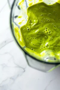 Green Protein Smoothie Bowl with Tropical Fruit 8 Thick and creamy green protein smoothie blended until perfectly smooth inside a blender.