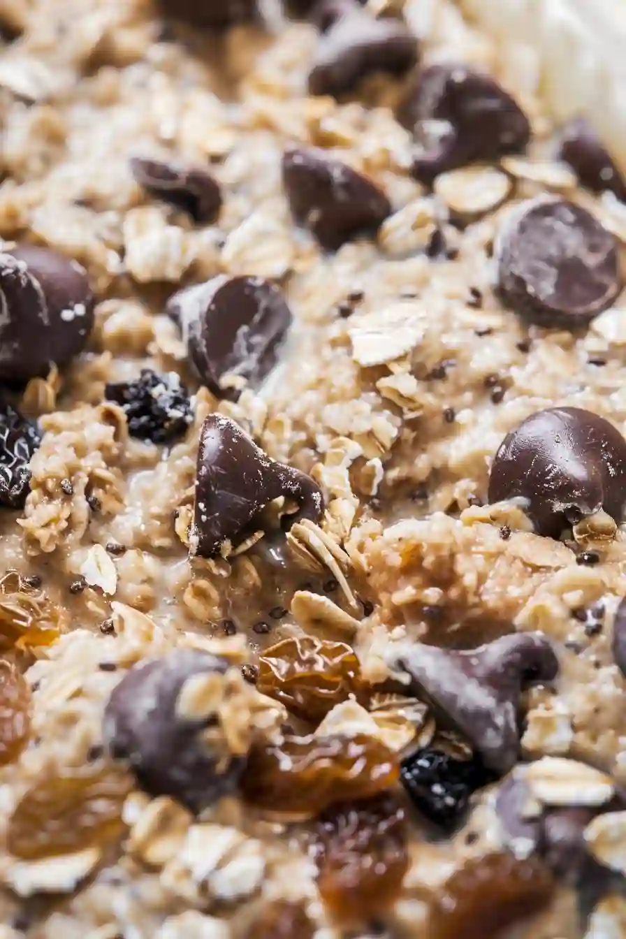Close-up of oatmeal protein ball mixture with chocolate chips and raisins evenly distributed throughout
