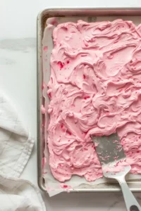 Raspberry Frozen Yogurt Bark 5 Raspberry yogurt mixture spread evenly onto a parchment-lined baking sheet before freezing.
