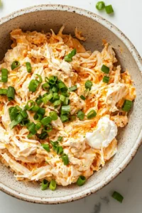 Creamy buffalo chicken filling made with shredded chicken, cream cheese, Greek yogurt, buffalo sauce, cheddar cheese, and green onions.