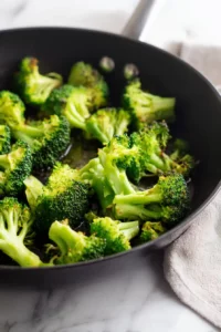 Garlic Butter Shrimp with Broccoli 3 Fresh broccoli florets cooking in a skillet until bright green with lightly charred edges.
