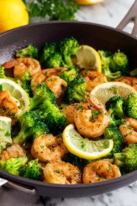 Garlic Butter Shrimp with Broccoli 6 Garlic butter shrimp and broccoli tossed together with fresh lemon slices in a skillet.