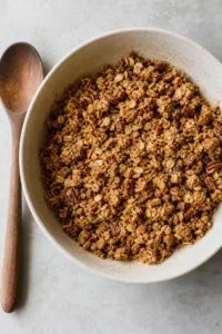 Healthy Cinnamon Apple Crisp 9 Crumbly oat, almond flour, pecan, coconut sugar, cinnamon, and melted butter topping in a mixing bowl